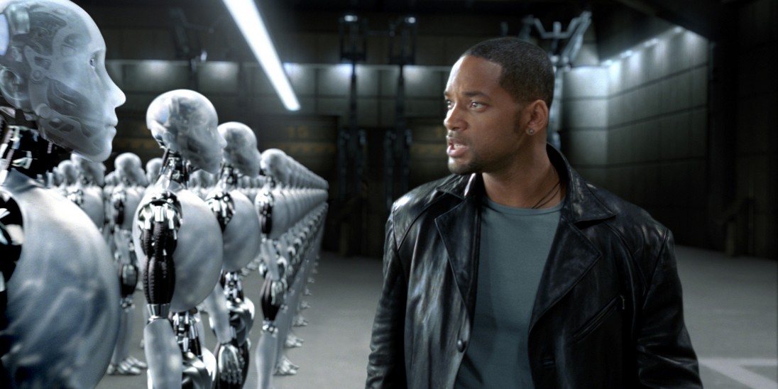 Screencapture from the movie “I, Robot” where actor Will Smith looks at a row of humanoid robots